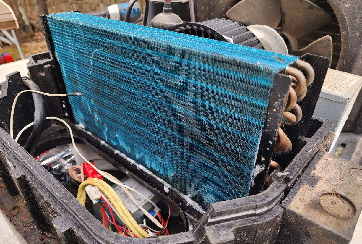 Mobile RV AC repair technician servicing HVAC system on the Treasure Coast